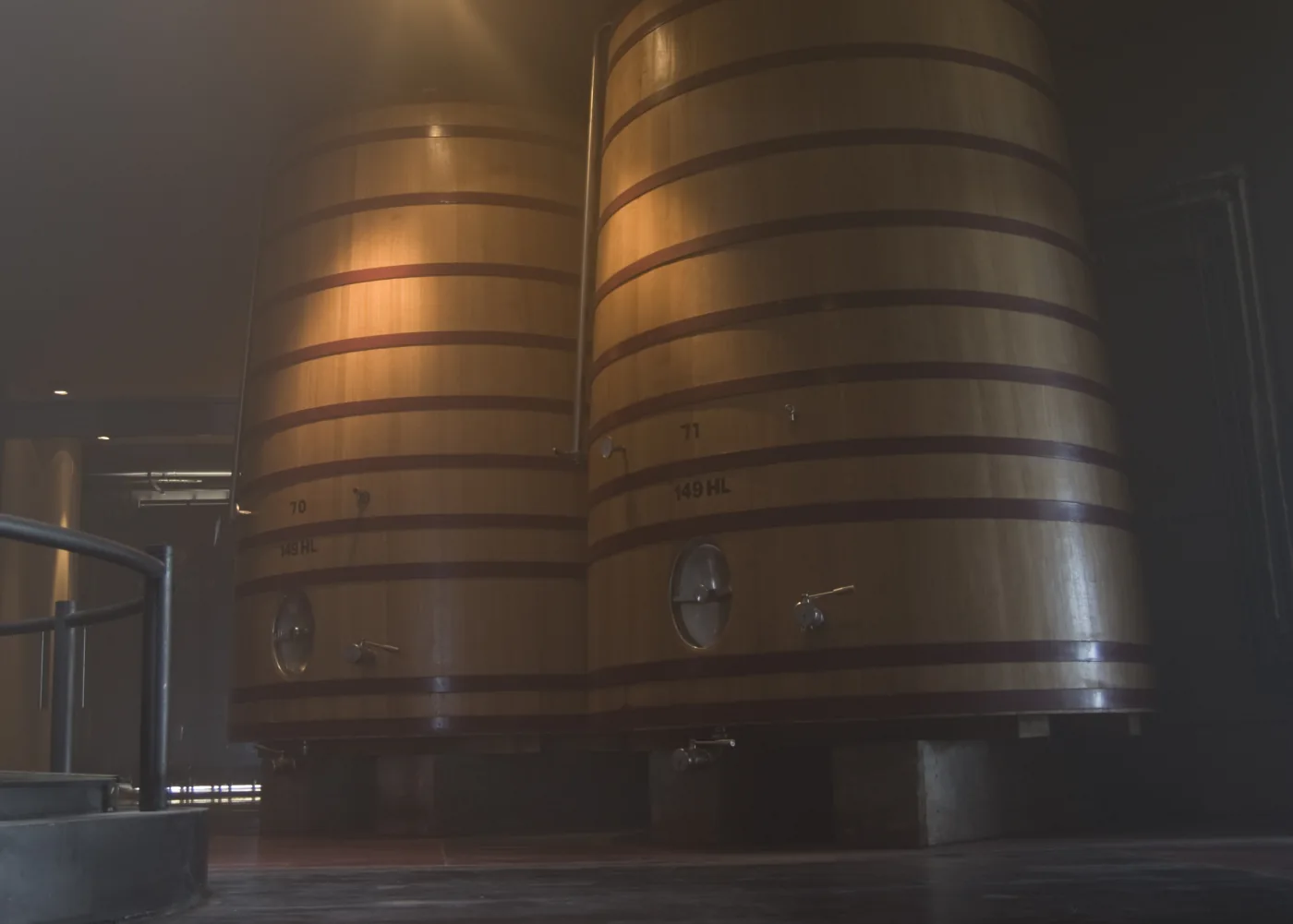 Large oak fermentation tanks inside O. Fournier winery in Mendoza